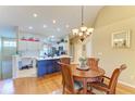 Kitchen and dining area with hardwood floors and island at 6620 Pineview Ter, Bradenton, FL 34203