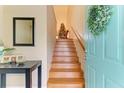 Bright entryway with wooden staircase and teal door at 6620 Pineview Ter, Bradenton, FL 34203