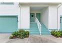 Exterior view showing teal colored front door and garage at 6620 Pineview Ter, Bradenton, FL 34203