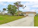 House exterior showcasing a well-maintained yard and driveway at 801 Church St, Nokomis, FL 34275