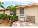 Front entrance with a bench and landscaped area at 801 Church St, Nokomis, FL 34275