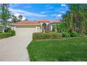 Single-story house with red tile roof, attached garage, and manicured lawn at 1109 Scherer Way, Osprey, FL 34229