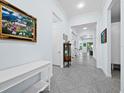 Bright and airy entryway with tile flooring and a white console table at 16528 Berwick Ter, Bradenton, FL 34202