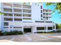 Condo building exterior featuring modern architecture and landscaped grounds at 2109 Gulf Of Mexico Dr # 1303, Longboat Key, FL 34228