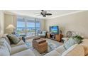 Bright living room with ocean views, comfortable seating, and sliding glass doors at 2109 Gulf Of Mexico Dr # 1303, Longboat Key, FL 34228