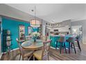 Dining area with teal accent wall and round wooden table at 4106 Central Sarasota Pkwy # 1026, Sarasota, FL 34238