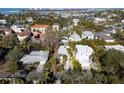 Aerial view showcasing a house nestled in a neighborhood with water access nearby at 4189 Roberts Point Cir, Sarasota, FL 34242