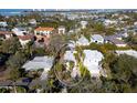 Aerial view of a single-Gathering home with a large backyard, located in a waterfront community at 4189 Roberts Point Cir, Sarasota, FL 34242