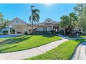 House exterior with lush landscaping and a paved walkway at 4712 Compass Dr, Bradenton, FL 34208