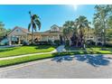 Tan house with palm trees, walkway, and driveway at 4712 Compass Dr, Bradenton, FL 34208