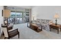 Living room features floral patterned sofa and easy access to the lanai at 6001 Cedarwood Ln, Bradenton, FL 34203