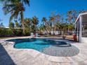 Inviting pool area with a freeform pool and spacious patio at 611 Hibiscus Way, Longboat Key, FL 34228