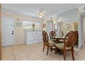 Bright dining area with glass-top table and four carved chairs at 6703 Midnight Pass Rd # 117, Sarasota, FL 34242