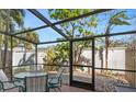 Relaxing screened patio with table and chairs, perfect for outdoor dining at 6703 Midnight Pass Rd # 117, Sarasota, FL 34242