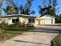 Single story home with attached garage and manicured lawn at 703 32Nd Street E Ct, Bradenton, FL 34208
