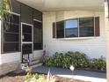 Front entrance of the home with a covered porch at 738 Riverview Cir, North Port, FL 34287