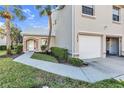 Exterior view of a light tan house with a two car garage at 7658 Sweetbay Cir # 2-101, Bradenton, FL 34203