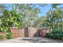 Brick entry gate with lion statues leading to a house at 7800 18Th W Ave, Bradenton, FL 34209