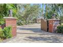 Ornate entry gate with lion statues and brick pillars at 7800 18Th W Ave, Bradenton, FL 34209