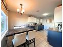 Eat-in kitchen with dark blue cabinets, wood countertops, and tile floor at 804 31St W St, Bradenton, FL 34205