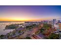 Stunning aerial view of the city, marina, and bay at sunset with colorful skies at 111 Golden Gate Pt # 403, Sarasota, FL 34236