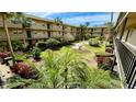 Community courtyard with lush landscaping and seating area at 11485 Oakhurst Rd # 200-220, Largo, FL 33774