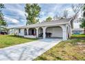 Front view of a single-story home with a driveway and grassy yard at 13479 Newport Ave, Port Charlotte, FL 33981