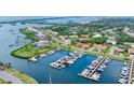 Expansive aerial view showcasing a home's location with a private marina and community amenities at 312 Yacht Harbor Dr, Osprey, FL 34229