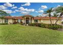 Beautiful home exterior with a red tile roof, manicured lawn, and inviting curb appeal at 312 Yacht Harbor Dr, Osprey, FL 34229