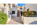 Front entrance of a condo building with stairs, landscaping, and mailboxes at 3530 Richwood Link # 46, Sarasota, FL 34235