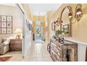 Bright entryway with tile floors and a mirrored dresser at 4451 Legacy Ct, Sarasota, FL 34241