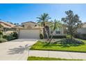 Exterior view of a single-story home with a two-car garage at 4451 Legacy Ct, Sarasota, FL 34241
