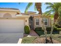 Front view of house with landscaped yard and palm trees at 4451 Legacy Ct, Sarasota, FL 34241