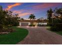 Beautiful updated home with a paver driveway and lush landscaping at 4884 Peregrine Point N Cir, Sarasota, FL 34231