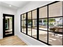 Glass wall showcases a beautiful pool and patio area at 741 Jacaranda Rd, Anna Maria, FL 34216
