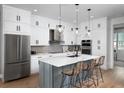 Modern kitchen with white cabinets, a large island, and stainless steel appliances at 9981 Key Haven Rd, Seminole, FL 33777