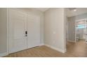 Light hardwood floors, white double doors, view of bathroom at 10142 Crystal Isles Cir, Sarasota, FL 34241