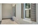 Side entrance with gray walls and dark brown shutters at 10142 Crystal Isles Cir, Sarasota, FL 34241