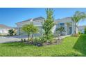 House exterior showcasing landscaping and a two-car garage at 10300 Lake George Ave, Sarasota, FL 34241