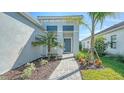 Welcoming front entry with a walkway and tropical landscaping at 10300 Lake George Ave, Sarasota, FL 34241