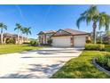 Single-Gathering house with three-car garage and palm trees at 12721 20Th E St, Parrish, FL 34219