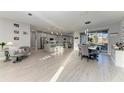 Open-concept living space featuring a dining area and modern kitchen with an island at 13951 Wood Duck Cir, Lakewood Ranch, FL 34202