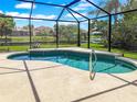 Relaxing screened-in pool with beautiful lake views and lush landscaping, perfect for enjoying the Florida lifestyle at 13951 Wood Duck Cir, Lakewood Ranch, FL 34202