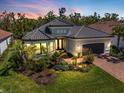 Charming single-story home with lush landscaping and a covered front entry at 15603 Derna Ter, Bradenton, FL 34211