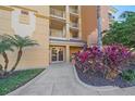 Condo building entrance with lush landscaping at 6482 Watercrest Way # 204, Lakewood Ranch, FL 34202