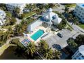 Aerial view of community pool, parking, and lush landscaping at 7830 34Th W Ave # 102, Bradenton, FL 34209