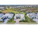 Aerial view of a house in a community with other houses and a conservation area at 7940 Redonda Loop, Bradenton, FL 34202