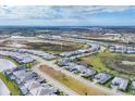Community overview showcasing numerous houses, landscaping, and a lake at 7940 Redonda Loop, Bradenton, FL 34202