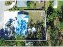 Aerial view showing house layout, yard, and surrounding trees at 1205 29Th W St, Bradenton, FL 34205