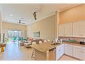 Open kitchen features granite countertops and white cabinets at 13816 Messina Loop # 203, Bradenton, FL 34211